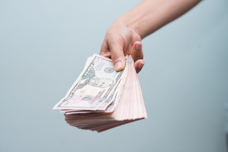 hand holding with moneyの写真素材
