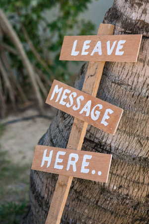 Leave message here wood lebel in garden, text