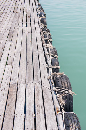 old tires at local port in Phuket, Thailand, waterの写真素材