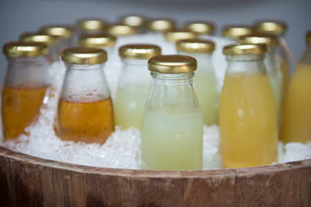 fresh fruit water in glass bottles, frozen in the iceの写真素材