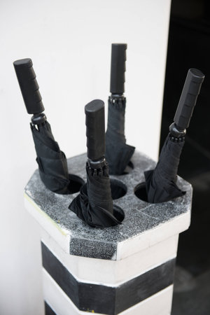Umbrella stand in hotel, parasolの写真素材