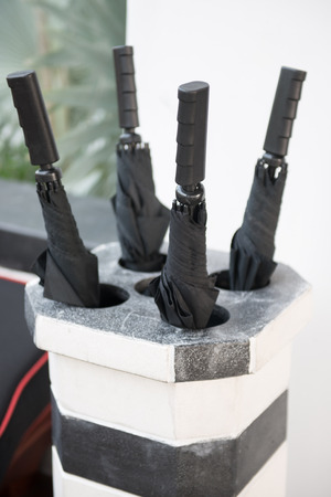 Umbrella stand in hotel, parasolの写真素材