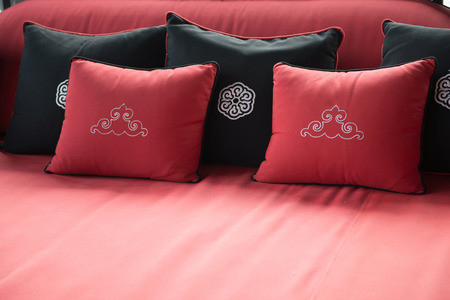 Black and red pillows placed on sofa, cushionの写真素材
