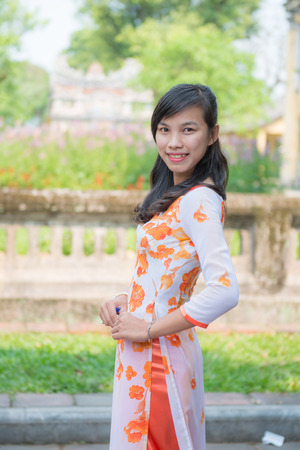 Hue, Vietnam Mar 15:: Vietnamese girl in national dress at The" Imperial" City or The Purple Forbidden City on March 15, 2015 Vietnamのeditorial素材