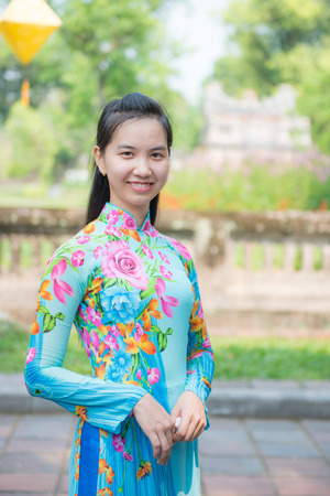 Hue, Vietnam Mar 15:: Vietnamese girl in national dress at The" Imperial" City or The Purple Forbidden City on March 15, 2015 Vietnamのeditorial素材