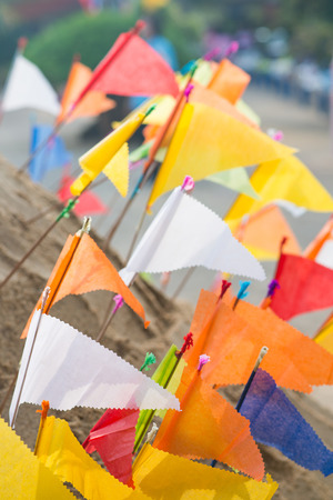 Thailand 13 Apr :: Sand and colorful flag for pray in Songkran Festival , on 13 April 2015 Thailandのeditorial素材