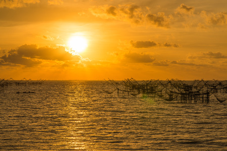 beautiful sunrise and giant trap fish in morning at Pakpra canal, Pattalung province Thailandの写真素材