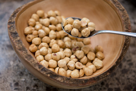 closeup of hazelnuts in wooden bowl, nutの写真素材