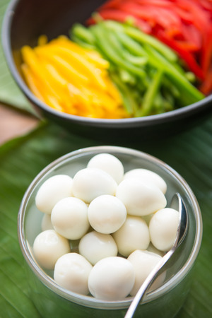 Boiled quail eggs and vegetable for salad in bowl, eatの写真素材