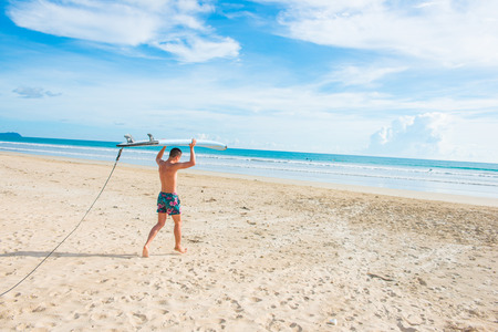 surfer man with surfboard on the beach, extremeの写真素材