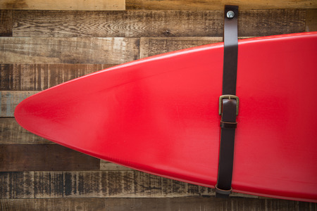 red surf board hang on the wood wall, home decorの写真素材