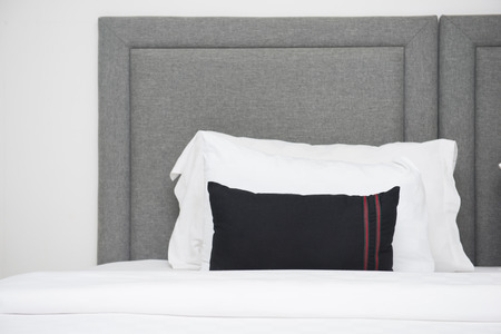 white pillows on the bed in bedroomの写真素材