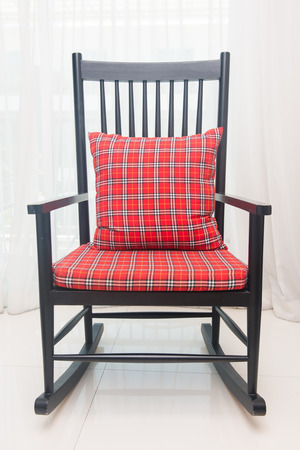 classic chair with red plaid pillow in living roomの写真素材
