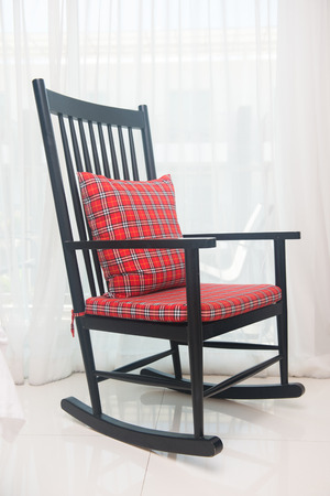 classic chair with red plaid pillow in living roomの写真素材
