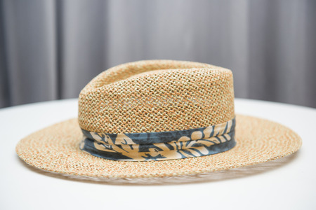 brown straw hat on white table, head-dressの写真素材