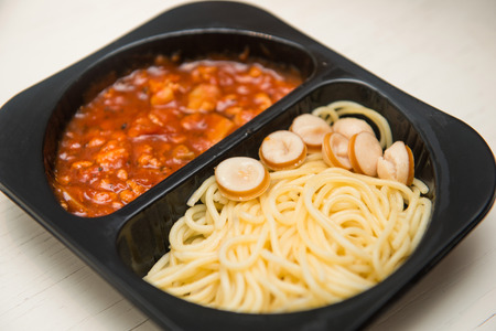 Spaghetti with tomato sauce in black plastic box, foodの写真素材