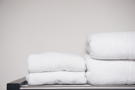 white towel placed on shelves in bathroom of hotel, fabricの写真素材