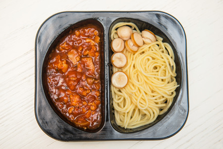 Spaghetti with tomato sauce in black plastic box, foodの写真素材