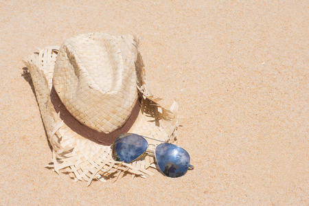 woven hats and sunglasses on the beach, fashionの写真素材
