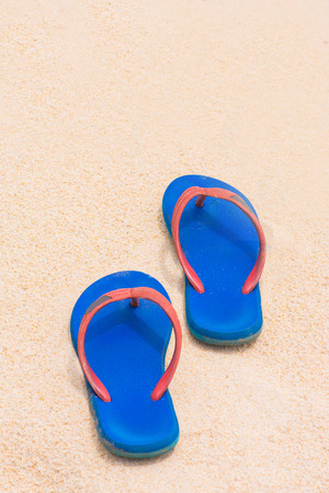 blue Rubber slippers on the sand, beachの写真素材