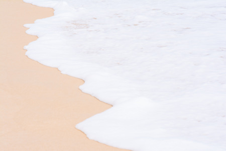 the white foam of wave on the sand, beachの写真素材