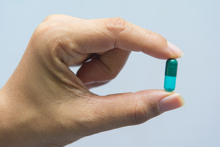 A woman holding pill capsules, drugの写真素材