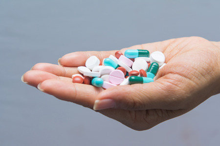 various tablets pills in hand, drugの写真素材