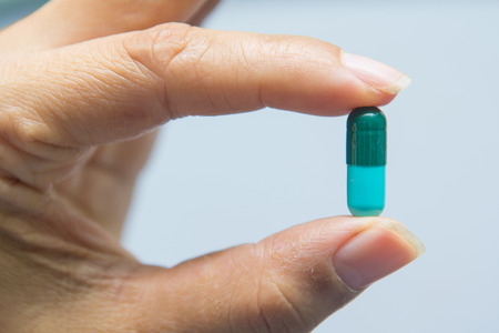 A woman holding pill capsules, drugの写真素材