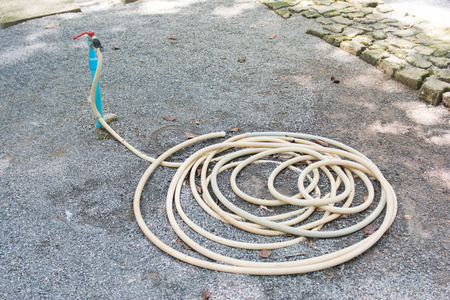 Hose watering and faucet in garden, toolの写真素材