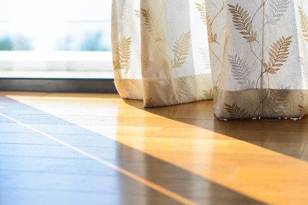 Shadow from shining through a window and the curtains, white roomの写真素材