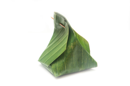 Thai dessert wrapped in banana leaves , cuisineの写真素材
