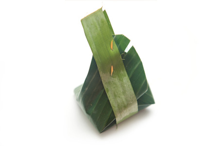 Thai dessert wrapped in banana leaves , cuisineの写真素材