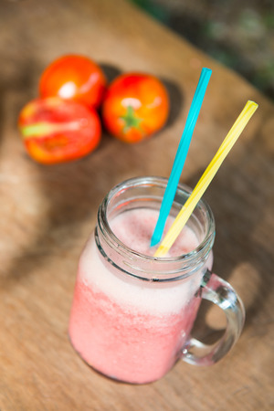 tomato smoothie with fresh tomato on plank, drinkの写真素材