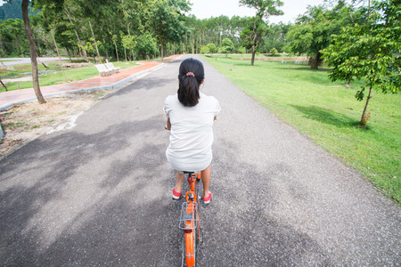 woman riding a bicycle in park, bikeの写真素材