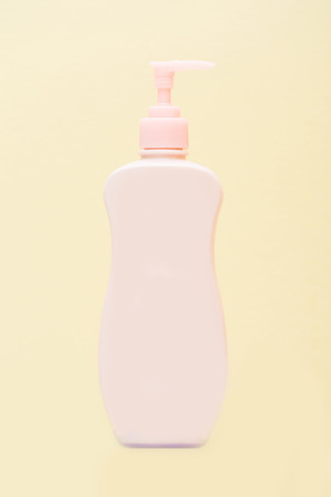 pink plastic bottles pump on yellow background, bottlesの写真素材
