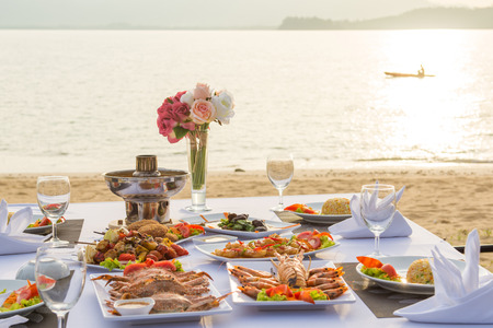 barbecue seafood for dinner by the sea, sunsetの写真素材