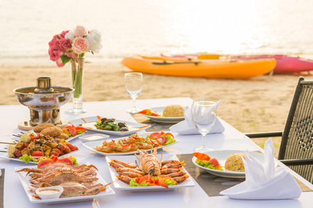 barbecue seafood for dinner by the sea, sunsetの写真素材