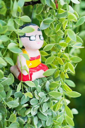 cute ceramic doll in plants, decorの写真素材