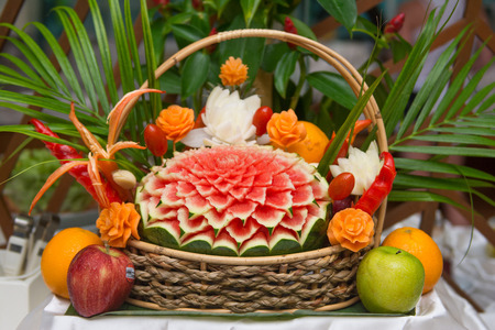 Thai fruit carving in wicker basket, decorationの写真素材