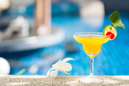 yellow cocktail with lime by the pool, drinkの写真素材