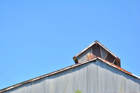 rusty zinc with blue sky, roofの写真素材