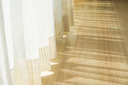 Shadow from shining through a door and the curtains, white roomの写真素材