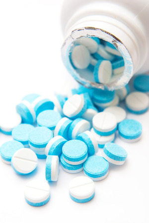 white and blue tablets pills from medicine bottles, drugsの写真素材