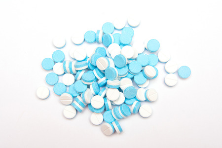 white and blue tablets pills on white background, drugsの写真素材