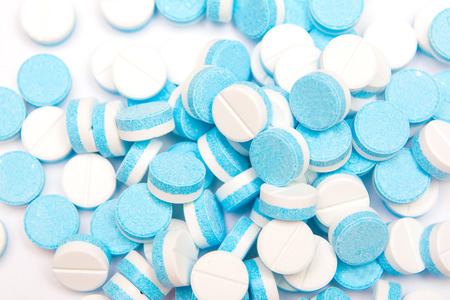 white and blue tablets pills on white background, drugsの写真素材