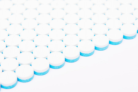 white and blue tablets pills on white background, drugsの写真素材