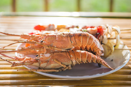 grilled barbecue chicken and lobster on dish, foodの写真素材