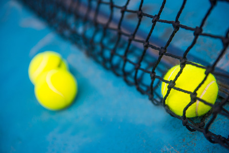 tennis ball on a tennis court with net, sportの写真素材