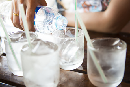 pouring water into the glass for drinking, drinkの写真素材