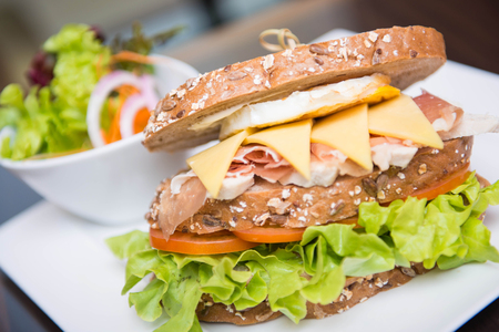 big sandwich for lunch with parma ham, egg, cheese, vegetableの写真素材